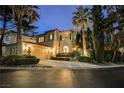 Elegant two-story home with a manicured lawn, mature trees, and a spacious driveway at 9000 Opus Dr, Las Vegas, NV 89117
