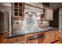 Gourmet kitchen featuring sleek appliances, custom cabinetry, and granite countertops at 9000 Opus Dr, Las Vegas, NV 89117