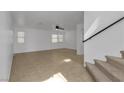 Bright living room with tile flooring, staircase and abundant natural light from multiple windows at 9290 S Cool Creek Ave, Las Vegas, NV 89147