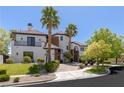Beautiful two story home featuring a manicured lawn, desert landscaping, and brick driveway at 9501 Balatta Canyon Ct, Las Vegas, NV 89144