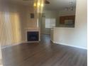 Living room with wood flooring, fireplace, and access to the kitchen and dining area at 1050 E Cactus Ave # 2110, Las Vegas, NV 89183