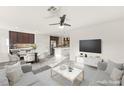 Open-concept living space with stylish furnishings, modern lighting, and large-screen TV at 10525 Shiny Skies Dr, Las Vegas, NV 89129