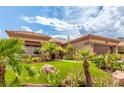 Charming home with lush front yard featuring desert plants and a well-maintained lawn at 10713 Shoalhaven Dr, Las Vegas, NV 89134