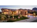 Beautiful single-story home with a well-manicured front yard and desert landscaping at dusk at 10713 Shoalhaven Dr, Las Vegas, NV 89134