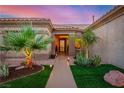 Inviting front entrance with manicured landscaping and a well-lit walkway at 10713 Shoalhaven Dr, Las Vegas, NV 89134