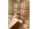 Cozy bathroom featuring a tub, neutral patterned shower curtain, and ample counter space by a mirror at 11021 Pentland Downs St, Las Vegas, NV 89141