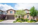 Charming two-story home showcasing a brick facade, well-manicured landscaping, and a spacious two-car garage at 12018 Vento Forte Ave, Las Vegas, NV 89138