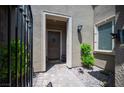 Inviting front entrance with a decorative gate, stylish lighting, and a charming welcome mat at 12018 Vento Forte Ave, Las Vegas, NV 89138