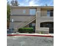 Exterior of a two-story apartment building with stairs and a small patio at 1401 N Michael Way # 244, Las Vegas, NV 89108