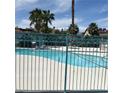 Community pool with surrounding iron fence and desert landscaping at 1401 N Michael Way # 244, Las Vegas, NV 89108