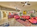 Inviting living room with plush red seating, tile floors, and a colorful rug at 150 Las Vegas Blvd # 1606, Las Vegas, NV 89101