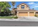 Well-maintained two-story home with three-car garage, mature trees, and lush landscaping in a quiet neighborhood at 1717 Double Arch Ct, Las Vegas, NV 89128