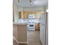 Kitchen with modern appliances, white countertops, and wooden cabinets at 1881 W Alexander Rd # 1128, North Las Vegas, NV 89032