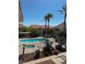 Community pool with palm trees and lounge chairs offers a relaxing outdoor space at 1881 W Alexander Rd # 1128, North Las Vegas, NV 89032