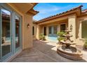 Inviting courtyard with a decorative fountain and double-door entrance at 2318 Shorewood Hills Ave, Henderson, NV 89052