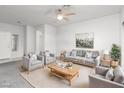 Bright living room with neutral tones, ceiling fan, and comfortable seating arrangement at 2557 Terrytown Ave, Henderson, NV 89052