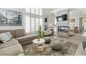 Inviting living room featuring large windows with shutters, fireplace and open concept to the dining area at 3367 Cheltenham St, Las Vegas, NV 89129