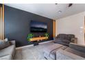 Modern living room with dark accent wall, decorative wood slats, and comfortable gray furniture at 3815 Corellia Ave, North Las Vegas, NV 89084