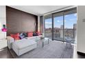 Cozy living room boasts city views from the large balcony, modern sofa, and stylish decor at 4381 W Flamingo Rd # 3120, Las Vegas, NV 89103