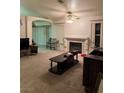 Inviting living room with fireplace, ceiling fan, and comfortable seating area at 4382 Valley Regal Way, North Las Vegas, NV 89032