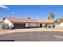 Charming single-story home featuring a tile roof, two-car garage, and well-maintained landscaping on a sunny day at 4454 Harmony Ct, Las Vegas, NV 89121