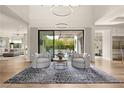 Bright open-concept living room showcasing modern lighting, wood floors, and seamless access to the outdoor patio at 5 Moonfire Dr, Las Vegas, NV 89135