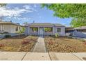 Inviting single-story home featuring a rock garden and a concrete walkway to the front door at 517 7Th St, Boulder City, NV 89005