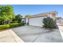 Attached two-car garage showcasing the driveway and landscaping at 5181 Morris St, Las Vegas, NV 89122
