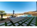Backyard pool and lounge area with desert landscaping and city views at 5436 Succulent Rose Dr, Las Vegas, NV 89135