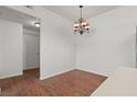 Dining area boasts laminate flooring and a modern chandelier at 5655 E Sahara Ave # 2044, Las Vegas, NV 89142