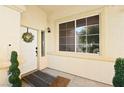 Inviting front porch with a decorative wreath on the door and a large window at 5832 Ivy Vine Ct, Las Vegas, NV 89141