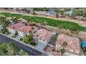 Aerial view of a well-manicured home with a golf course in the background at 62 Incline Village Ct, Henderson, NV 89074