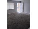 Spacious living room featuring carpet and a front door at 621 Van Ert Ave, North Las Vegas, NV 89030