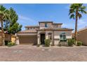 Charming two-story home boasting a Spanish tile roof, attached two-car garage, and well-manicured landscaping at 63 Via Di Mello, Henderson, NV 89011