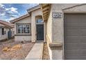 Close up of the front entrance and two car garage of a charming single story home at 6438 Rose Tree Ln, Las Vegas, NV 89156