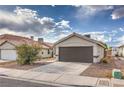 Single-story home boasting a two car garage and minimal desert landscaping at 6438 Rose Tree Ln, Las Vegas, NV 89156