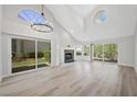 Open floor plan living room featuring new floors and lots of natural light at 7012 Bright Springs Ct, Las Vegas, NV 89113