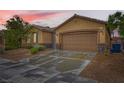 Inviting single-story home boasts an attached two-car garage, stone accents, and well-maintained front yard at 7497 Alamo Ranch Ave, Las Vegas, NV 89179