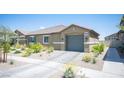 Charming single-story home featuring desert landscaping and a two-car garage at 7890 Aurora Sky St # 1, North Las Vegas, NV 89084