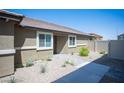 Charming single-story home featuring desert landscaping with walkway to front door at 7890 Aurora Sky St # 1, North Las Vegas, NV 89084