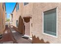 A narrow side yard showing a walkway leading to the back of the house at 8059 Wards Ferry St, Las Vegas, NV 89139