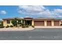 Charming single-story home with a three-car garage, desert landscaping, and a stone entryway at 8985 S Tomsik St, Las Vegas, NV 89113