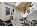 Cozy front porch with seating area, decorative wall art, and security door at , Las Vegas, NV 89118