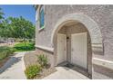 A pair of entry doors behind a stone-look archway at 10001 Peace Way # 2335, Las Vegas, NV 89147