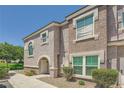 View of the exterior of the home showing the walkway and landscaping at 10001 Peace Way # 2335, Las Vegas, NV 89147
