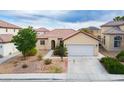 Charming single-story home with a two-car garage and well-maintained landscaping, offering great curb appeal at 1027 Dawn Valley Dr, North Las Vegas, NV 89031