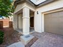 Charming covered entryway with stone accents, leading to the front door and attached two-car garage at 1030 Maple Pines Ave, North Las Vegas, NV 89081