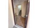 View into the entryway of the home featuring tile floors and a staircase at 1030 Maple Pines Ave, North Las Vegas, NV 89081