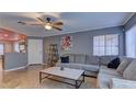 Inviting living room boasts tile floors, ceiling fan, and neutral paint, creating a cozy atmosphere at 10456 Processor Ct, Las Vegas, NV 89129
