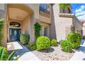 Charming home featuring a blue front door and well-manicured landscaping at 1701 Tesara Vista Pl, Las Vegas, NV 89128